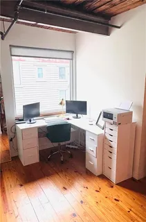a view of a workspace with furniture