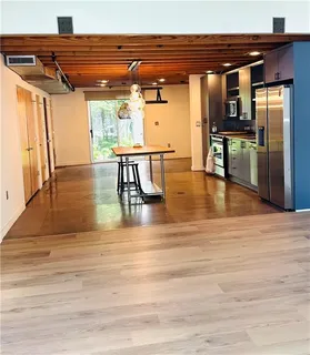 a view of kitchen with furniture and wooden floor
