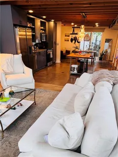 a living room with furniture and flat screen tv