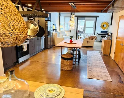 a outdoor dining space with furniture and a rug