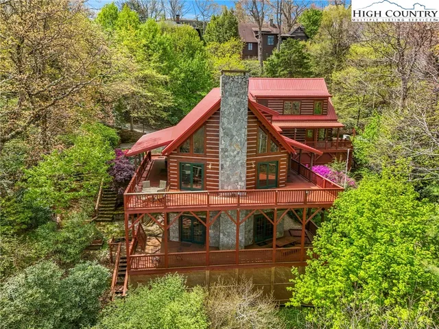 a view of a house with pool and windows