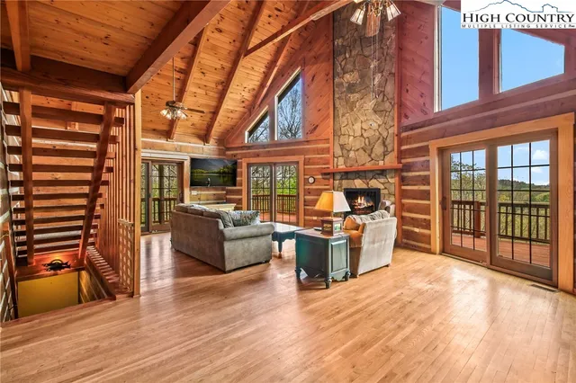 a living room with furniture a fireplace and wooden floor