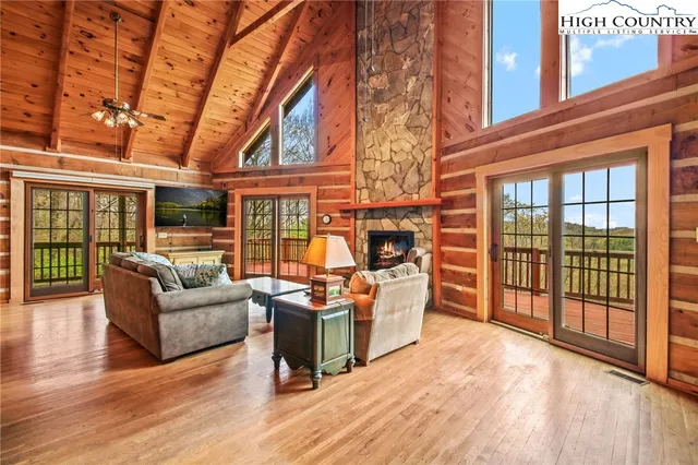 a living room with furniture a fireplace and a table