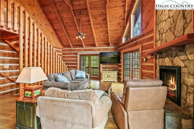 a living room with furniture fireplace and flat screen tv