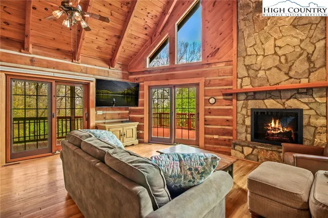 a living room with furniture a fireplace and a flat screen tv