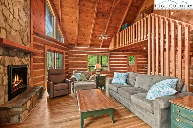 a view of a livingroom with fireplace and furniture