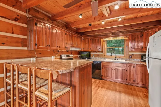 a kitchen with wooden cabinets and a stove top oven