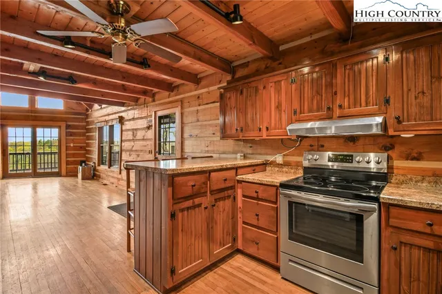a kitchen with granite countertop a sink stainless steel appliances and cabinets