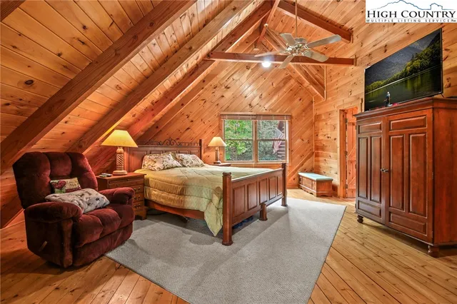 a bedroom with furniture and a flat screen tv