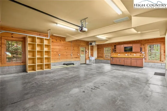 a kitchen with stainless steel appliances kitchen island granite countertop a refrigerator and a stove top oven