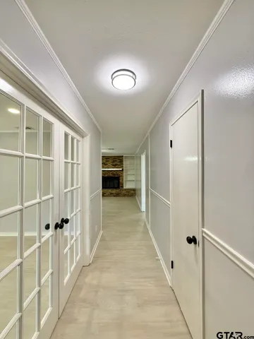 a view of a hallway with wooden shelves