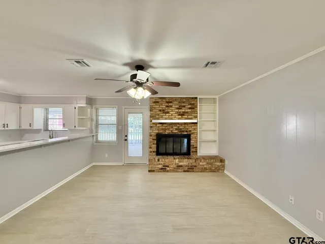 a view of a livingroom with a fireplace and chandelier