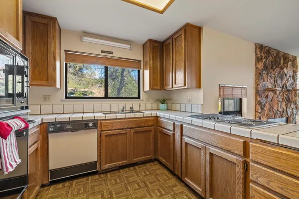 a kitchen with a sink stove and cabinets