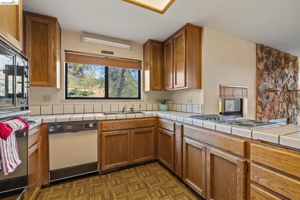 a kitchen with a sink stove and cabinets