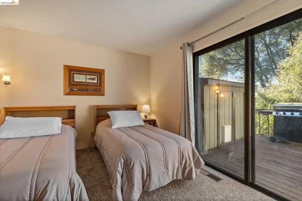 a bedroom with a bed and a large window