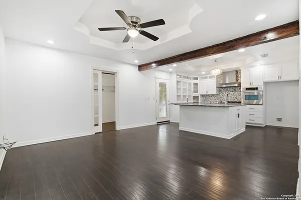 a view of a kitchen with a sink and refrigerator