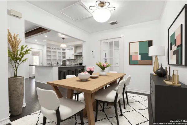 a view of a dining room with furniture and a chandelier