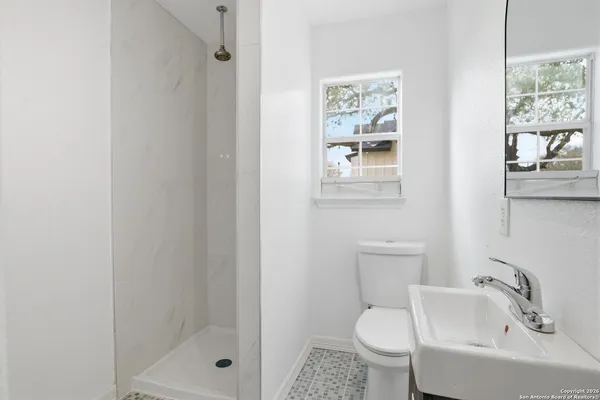 a bathroom with a toilet sink and shower