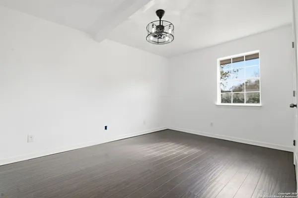 a view of a room with wooden floor and window