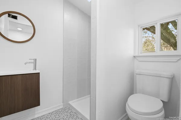 a white toilet sitting next to a bathroom sink