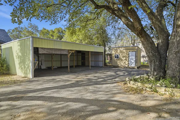 a view of a house with a tree in the background