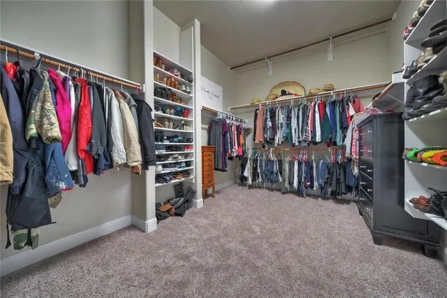 a large kitchen with kitchen island a sink stainless steel appliances and cabinets