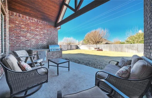 a view of a hallway with workspace and a couch