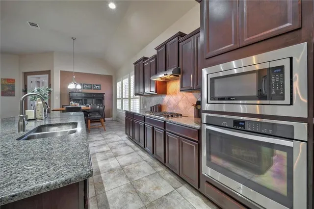 a kitchen with sink cabinets and appliances