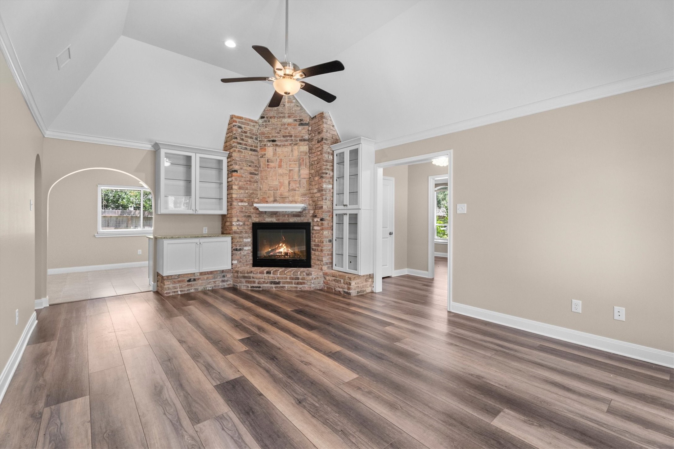 6530 Bayonne Drive Spring, TX 77389 - Photo 23 of 37 an empty room with wooden floor fireplace and windows