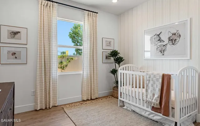 a view of a bedroom with furniture and windows