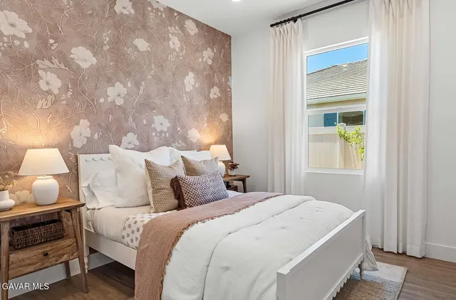 a bedroom with bed and window