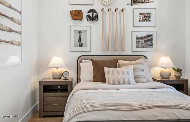 a bedroom with bed and painting on the wall