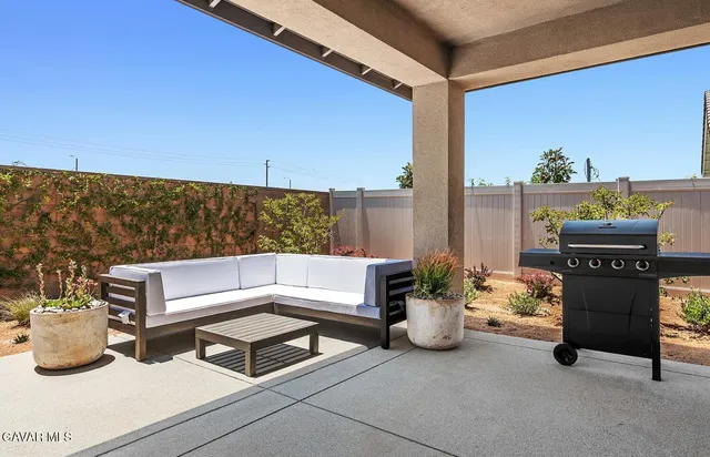 a outdoor living space with furniture and a potted plant