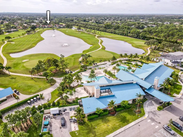 an aerial view of residential houses with outdoor space and river