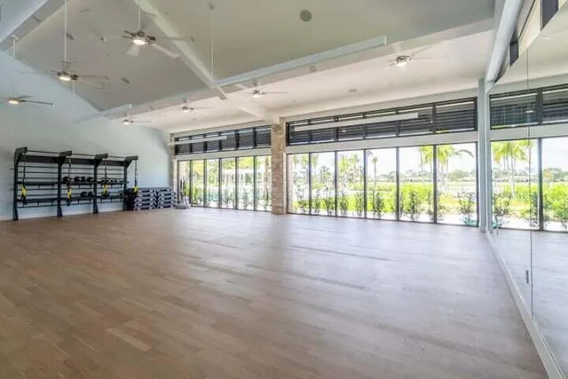 an empty room with windows and stairs
