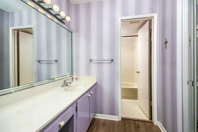 a bathroom with a sink a mirror and a shower