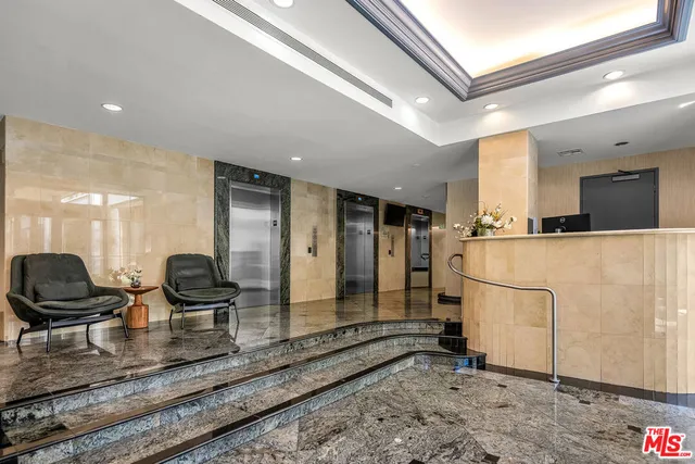 a living room with stainless steel appliances kitchen island granite countertop furniture and a rug