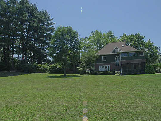 2856 South Lowden Road Oregon, IL 61061 - Photo 3 of 8 a front view of a house with a garden