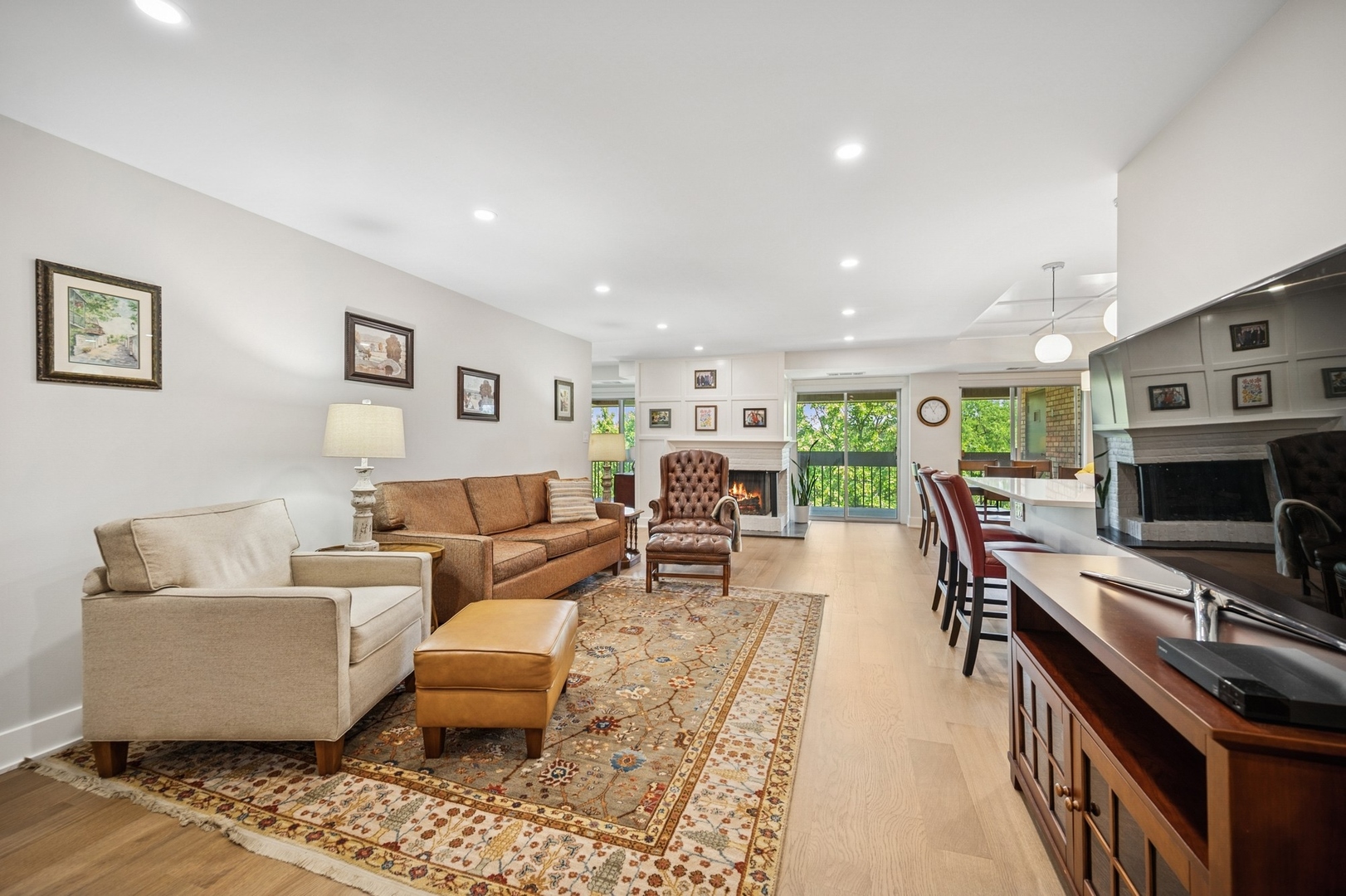 3801 Mission Hills Road, Unit 510 Northbrook, IL 60062 - Photo 3 of 19 a living room with furniture a flat screen tv and a fireplace