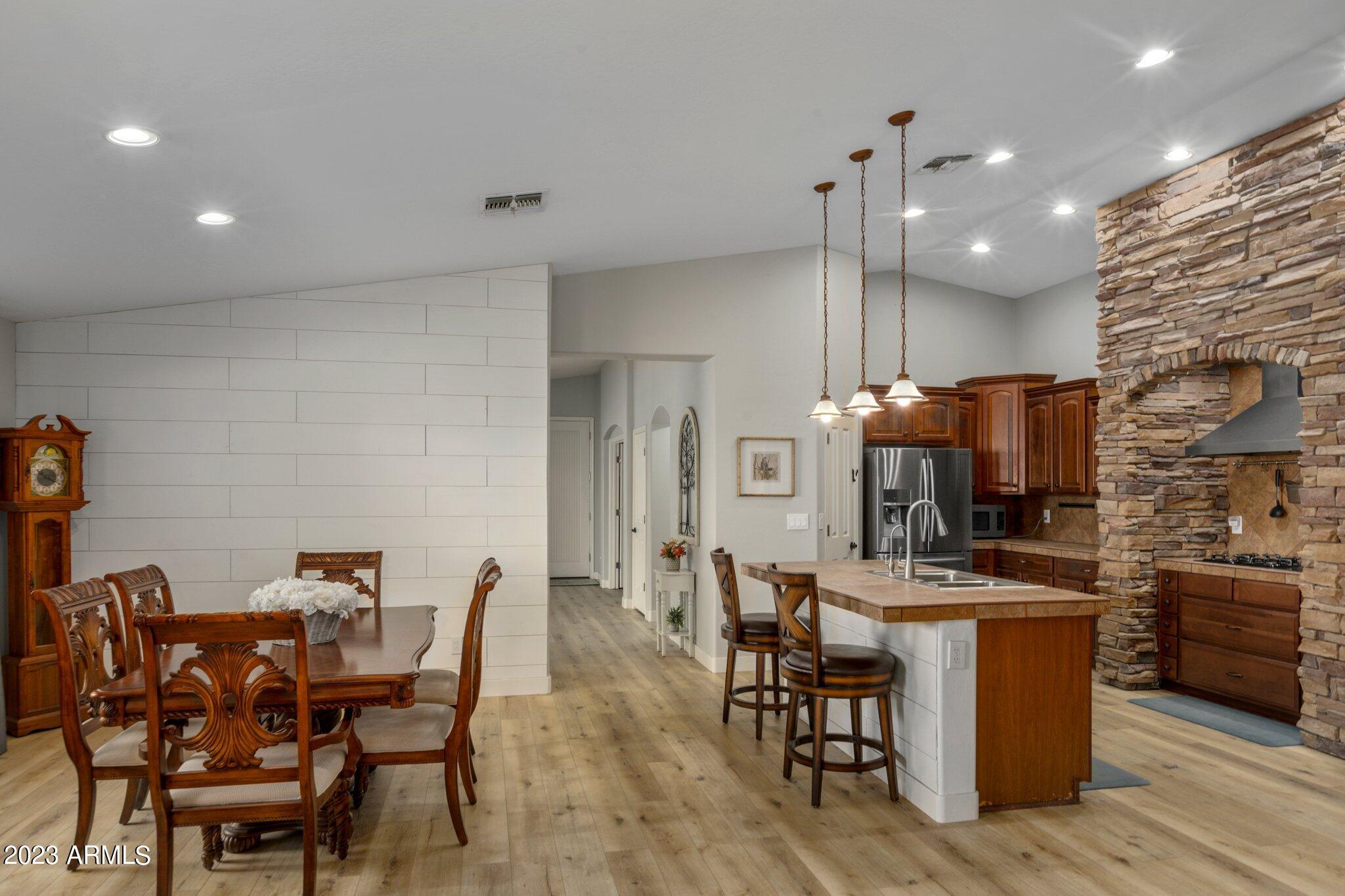 4565 East Ruffian Road Gilbert, AZ 85297 - Photo 14 of 47 a view of a dining room with furniture and wooden floor