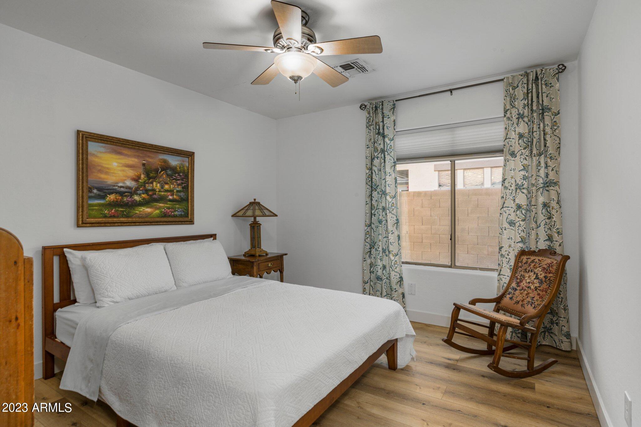 4565 East Ruffian Road Gilbert, AZ 85297 - Photo 22 of 47 a bedroom with a bed and wooden floor