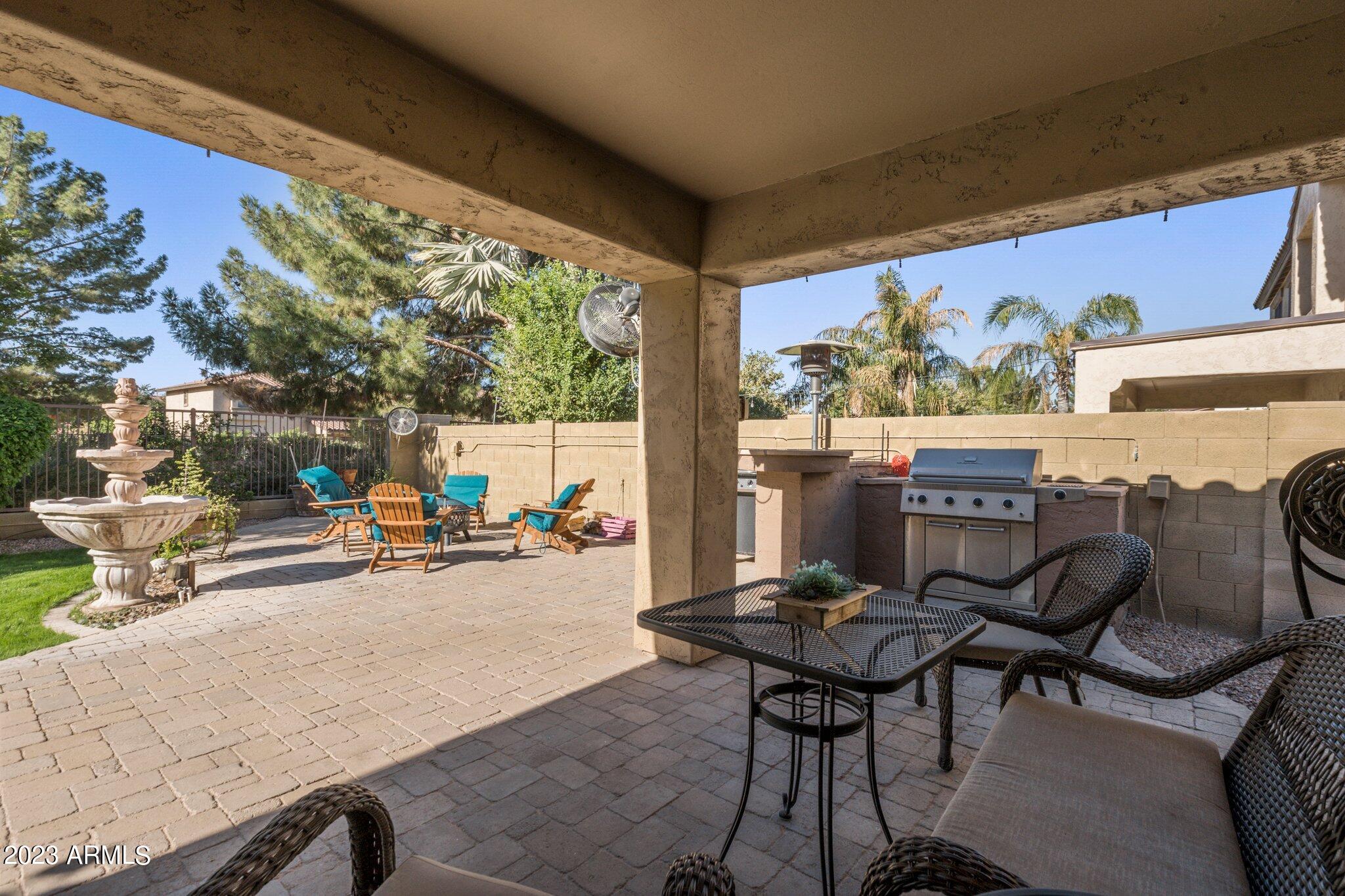 4565 East Ruffian Road Gilbert, AZ 85297 - Photo 24 of 47 a view of a patio with table and chairs and potted plants