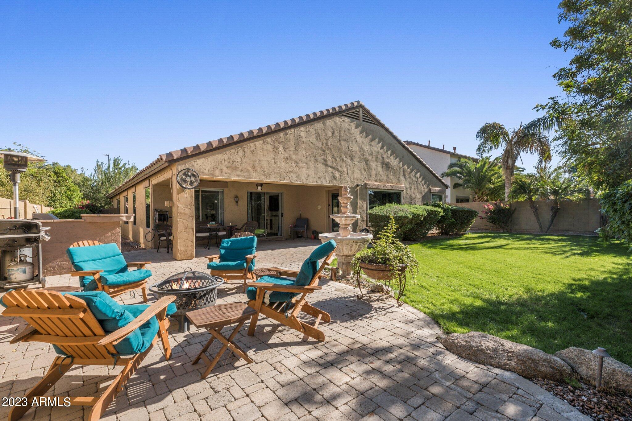4565 East Ruffian Road Gilbert, AZ 85297 - Photo 26 of 47 a view of a patio with table and chairs and potted plants