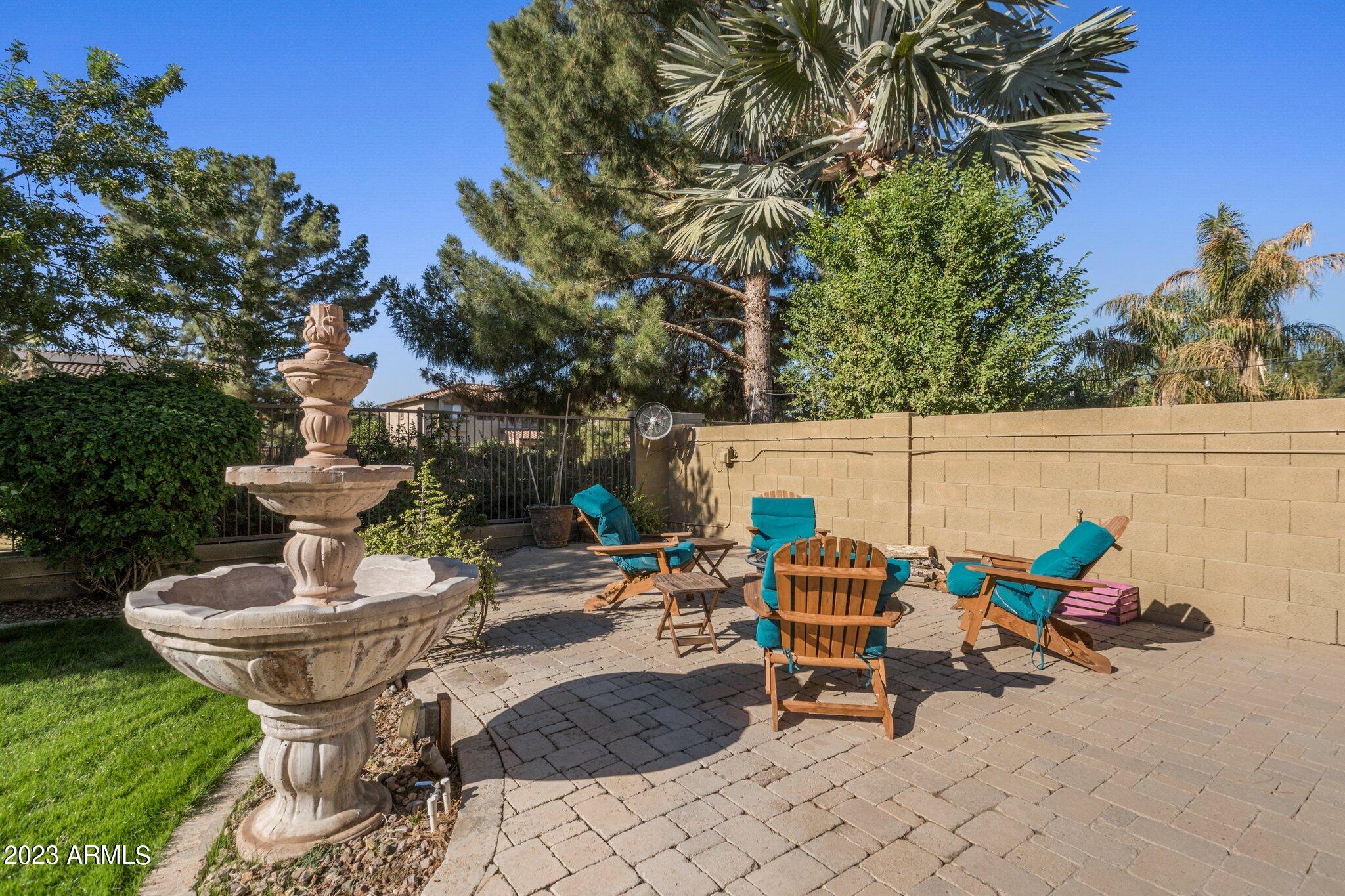 4565 East Ruffian Road Gilbert, AZ 85297 - Photo 27 of 47 a chairs and tables in the backyard of a house