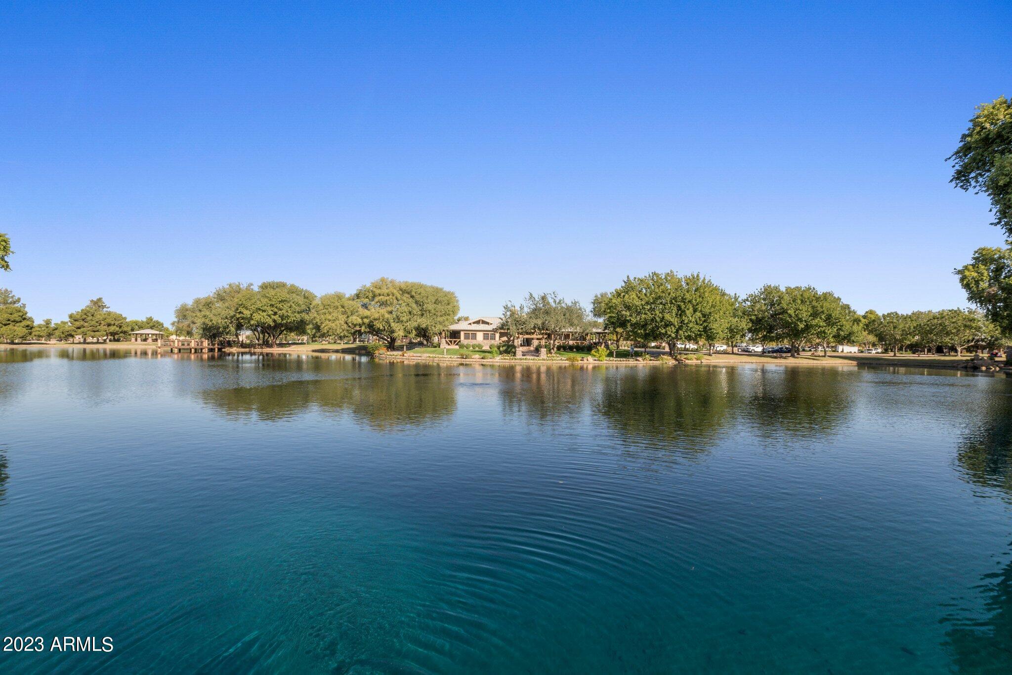 4565 East Ruffian Road Gilbert, AZ 85297 - Photo 39 of 47 a view of a lake with houses in the background