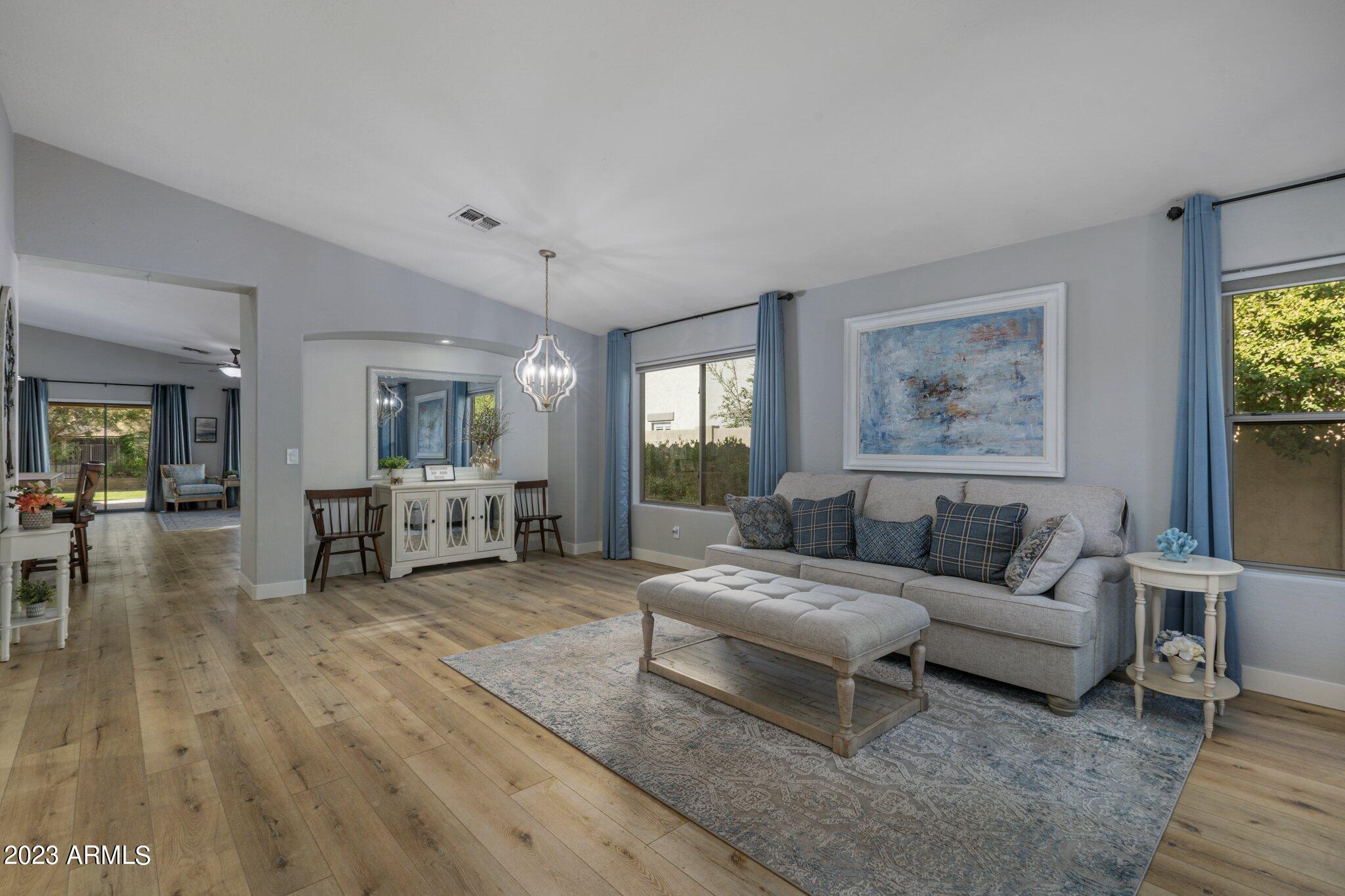 4565 East Ruffian Road Gilbert, AZ 85297 - Photo 4 of 47 a living room with furniture and a wooden floor