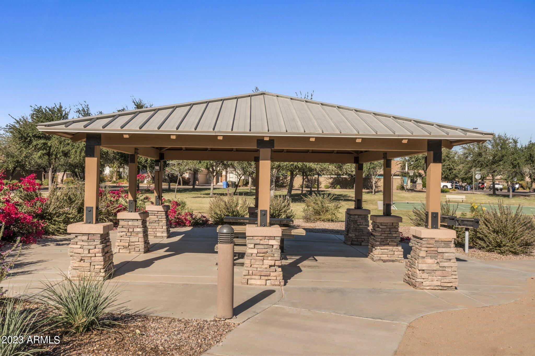 4565 East Ruffian Road Gilbert, AZ 85297 - Photo 41 of 47 a patio with a table and chairs under an umbrella