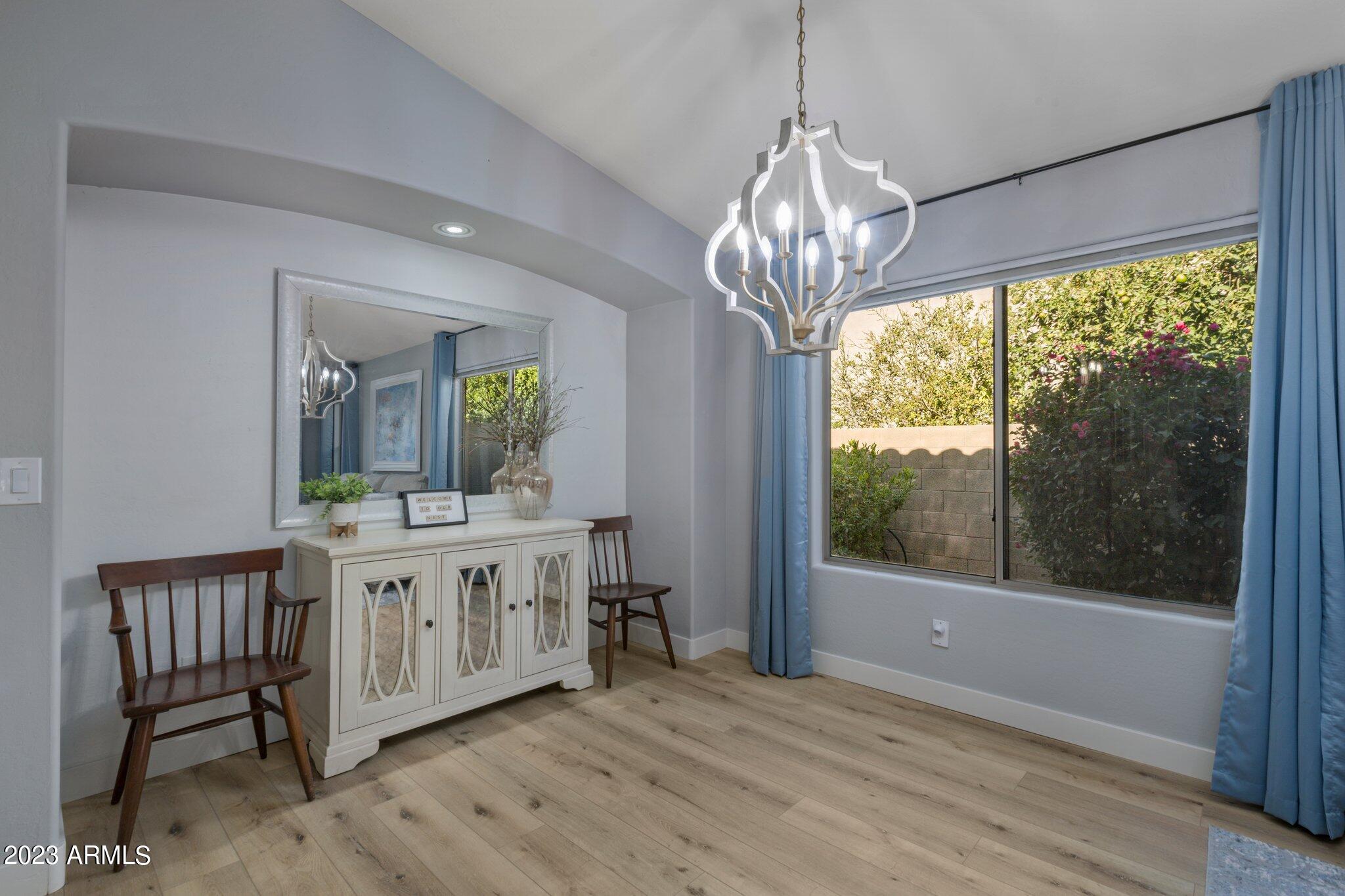 4565 East Ruffian Road Gilbert, AZ 85297 - Photo 7 of 47 a view of a room with a chandelier and wooden floor
