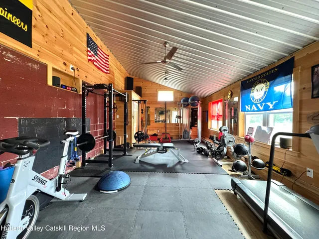 a view of a living room with floor to ceiling window and wooden floor