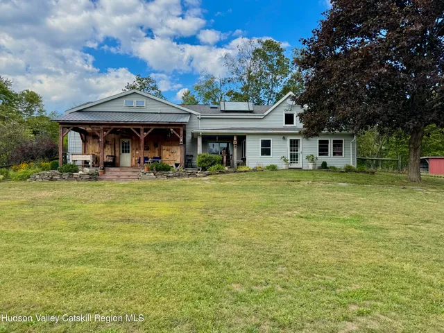 a front view of house with yard and green space